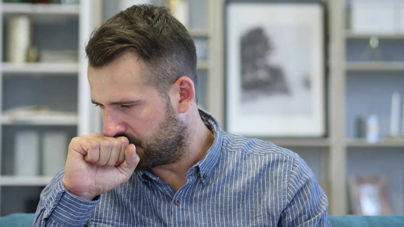 man coughing due to mold