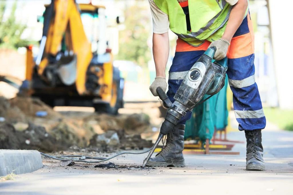 Road construction worker with perforator