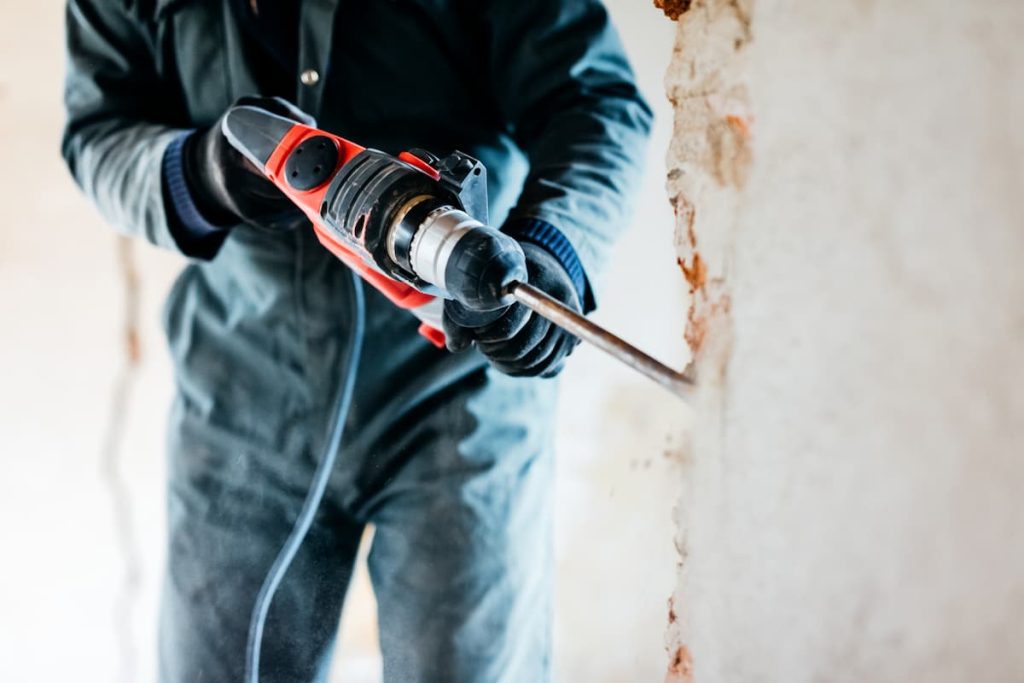 Missouri workers using a hammer drill