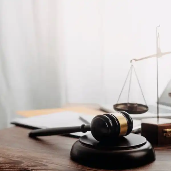 gavel next to scales of justice and laptop