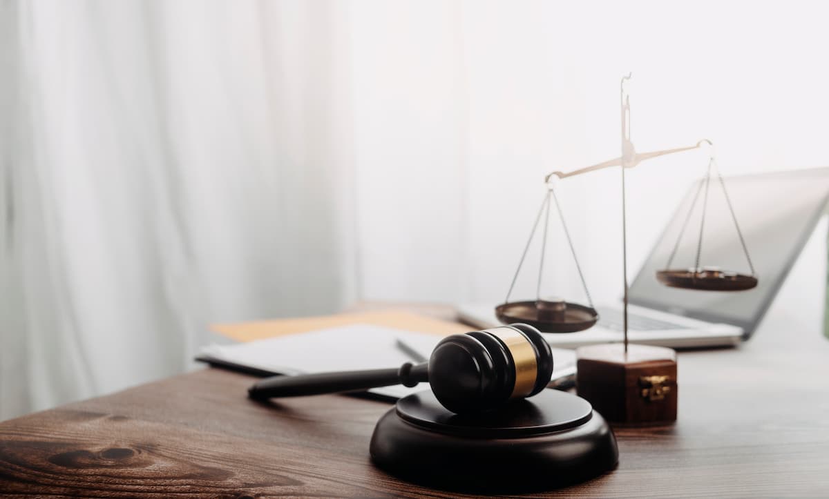 gavel next to scales of justice and laptop