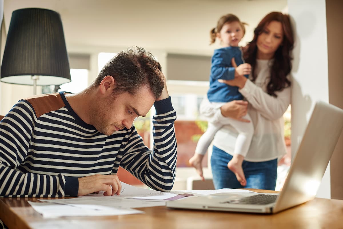 father stresses over bills after a work injury