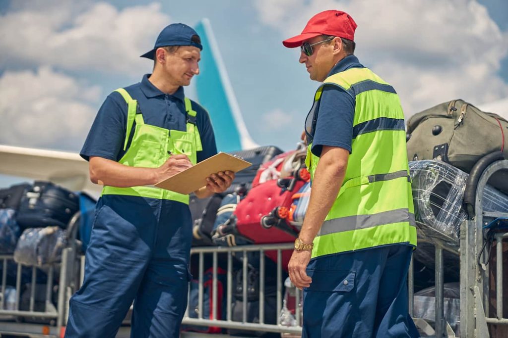 airport workers handling baggage