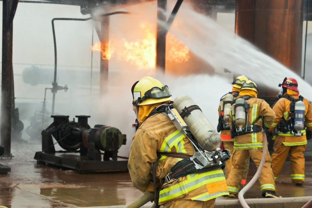 firefighters at the scene of a workplace explosion