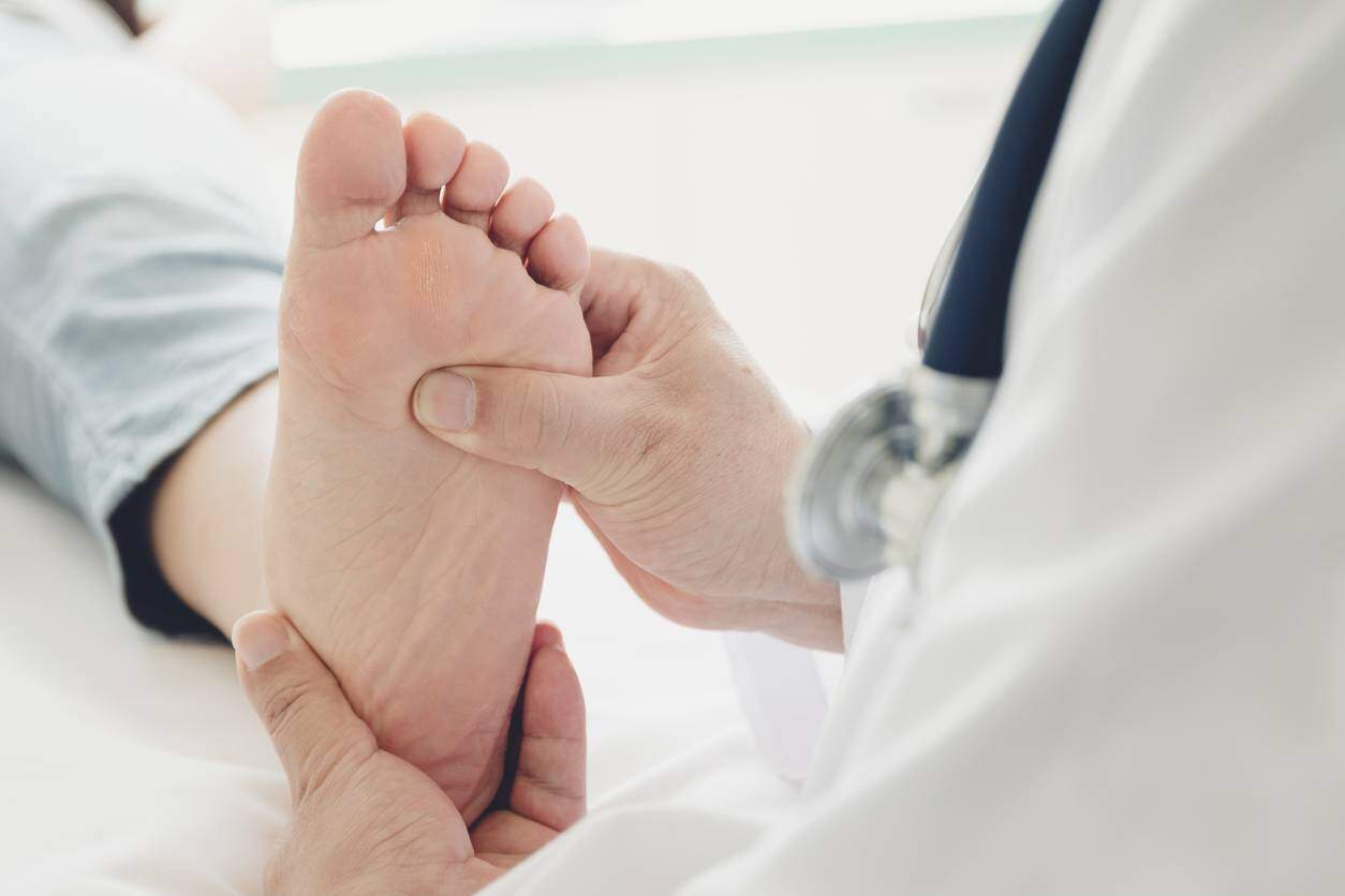 having foot examined by a doctor