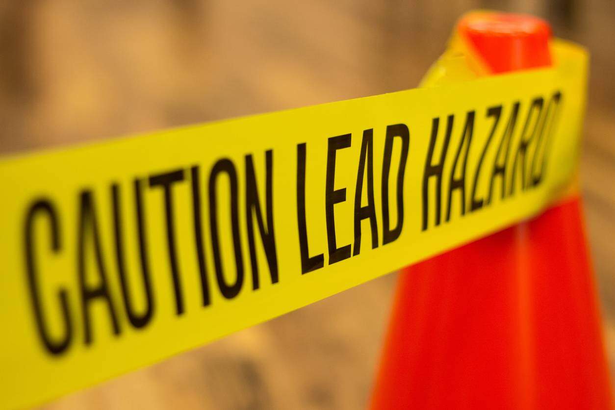 caution lead sign at work
