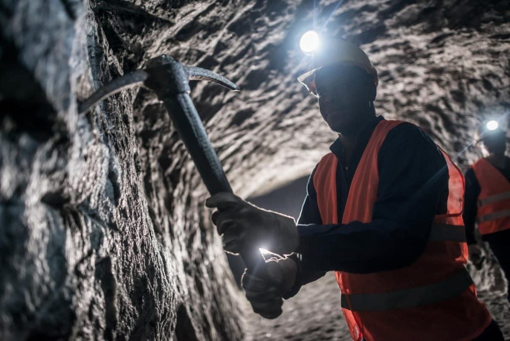 miner using a pick tool