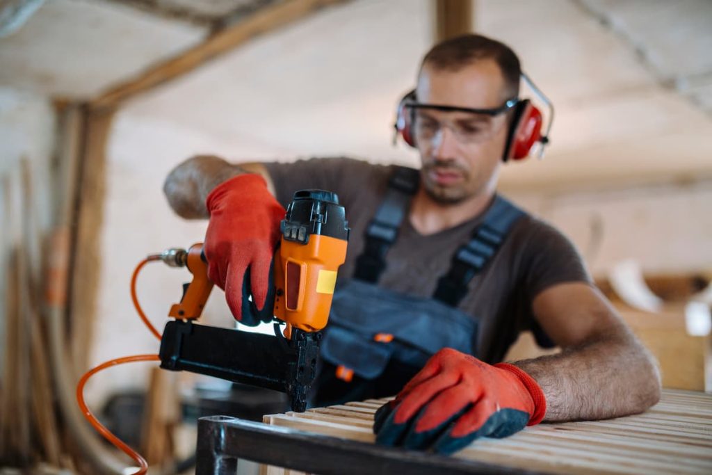 missouri construction worker using a nail gun