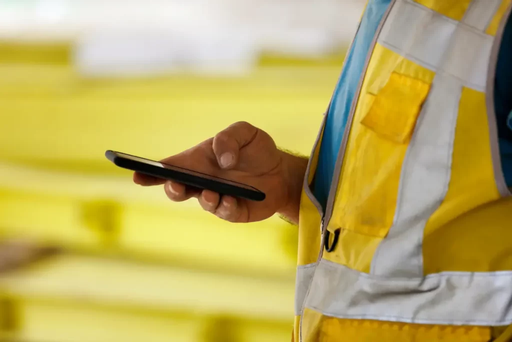 construction worker checking their smartphone