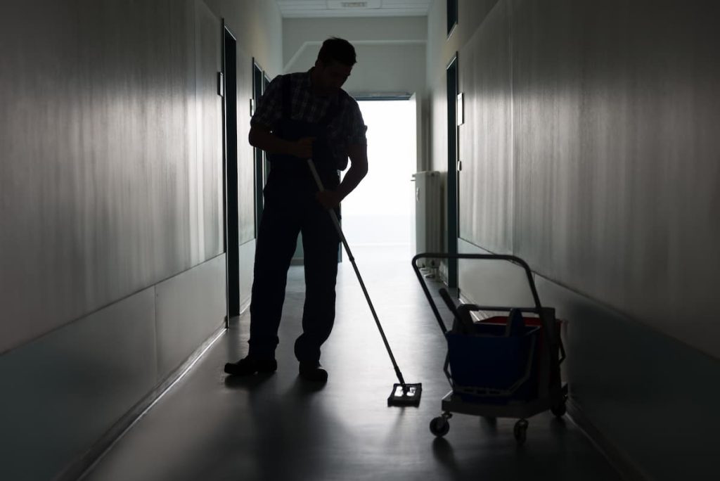 St. Louis janitor cleaning hallway floor