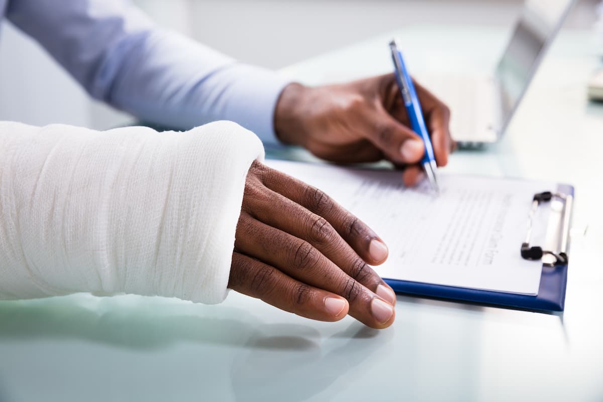 injured worker filing out workers comp paperwork