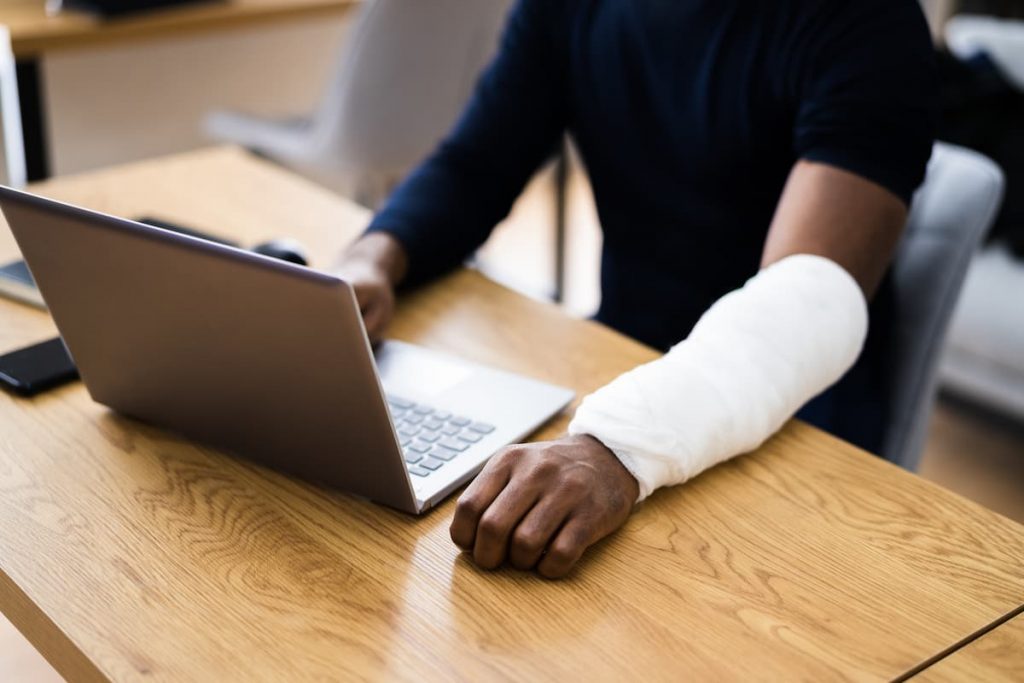 injured workers on a laptop