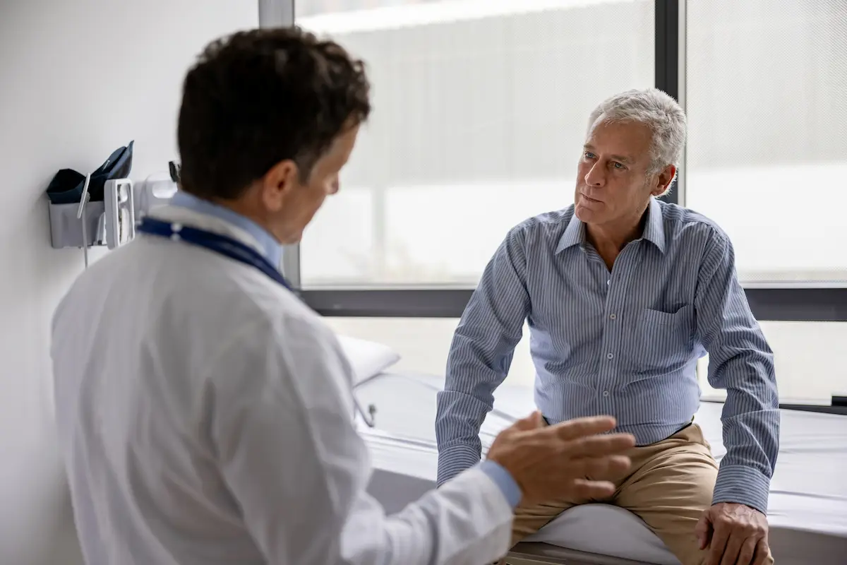 an injured worker speaks with a doctor